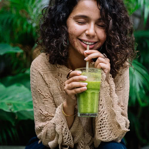 Young Woman Drinking Green Juice